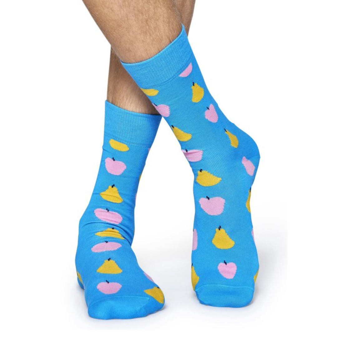 Model wearing blue socks with apple and pear design