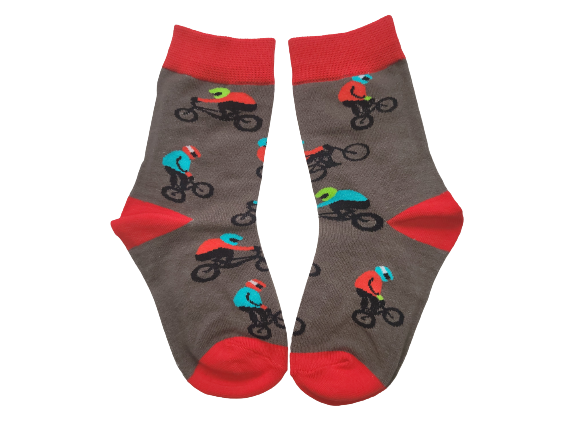 Grey and red socks with bmx riders laid flat