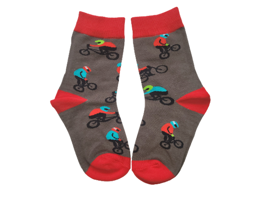 Grey and red socks with bmx riders laid flat