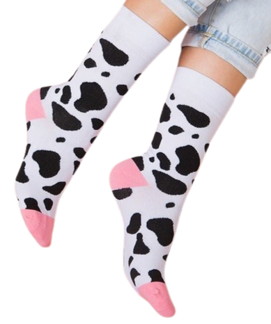 Black and white cow print socks worn by model