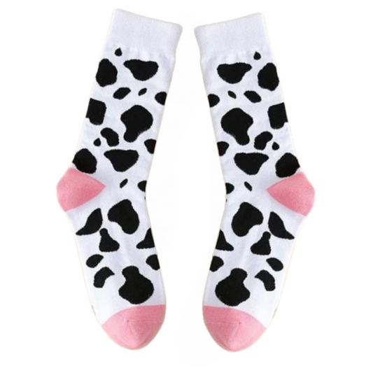 Pair of socks with cow print and pink accents on a white background