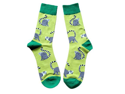 Green socks with grey lemurs laid flat on a white background