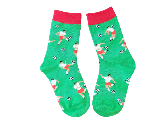 Green socks with red cuff featuring soccer players on a field laid flat