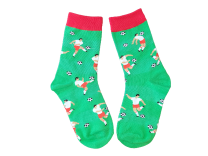 Green socks with red cuff featuring soccer players on a field laid flat