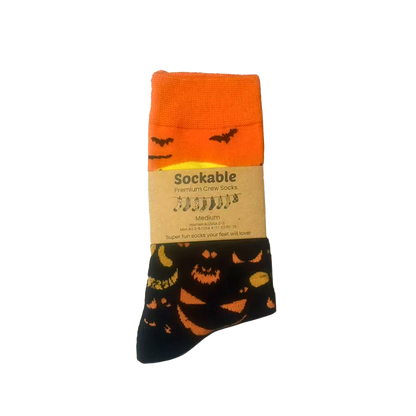 Halloween-themed socks with pumpkins and bats on a white background