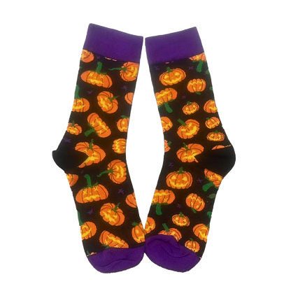 Halloween-themed socks with pumpkins on a black background