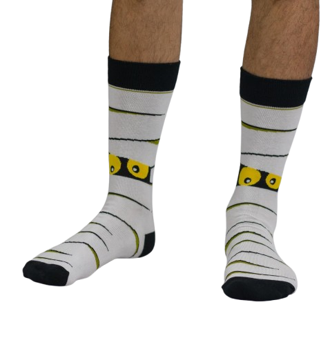 White Halloween themed socks with a Mummy worn by a person on a white background