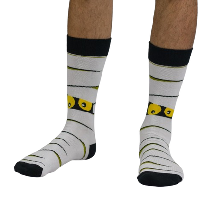 White Halloween themed socks with a Mummy worn by a person on a white background