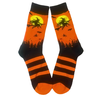 Halloween-themed socks with witch on broom design on an orange background