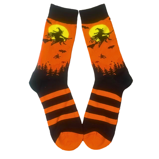 Halloween-themed socks with witch on broom design on an orange background