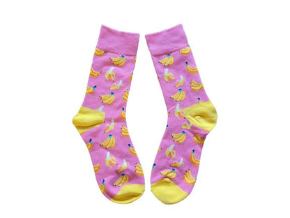 Pink socks with banana pattern on a white background