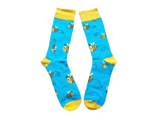 Blue and yellow buzzy bee socks laid flat on a white background